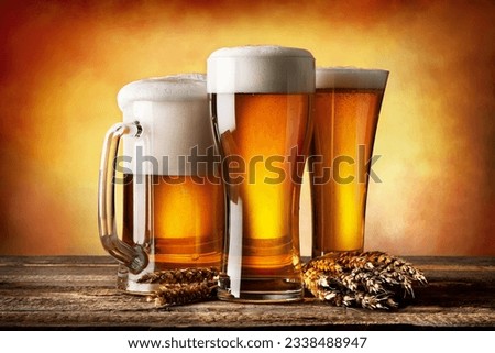 Three beers and wheat on a yellow background