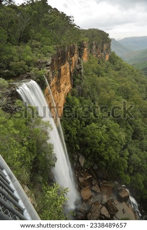 Views of Fitzroy Falls from the grated balcony lookout at the top of the escarpment with a downward perspective capturing the first of the spectacular falls iover sheer vertical cliffs nto the eucalyp
