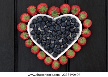Blueberry and strawberry antioxadant fruit in and around a heart shaped dish.