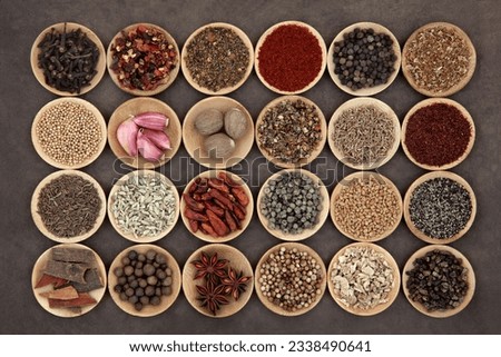Large middle eastern spice selection in wooden bowls.