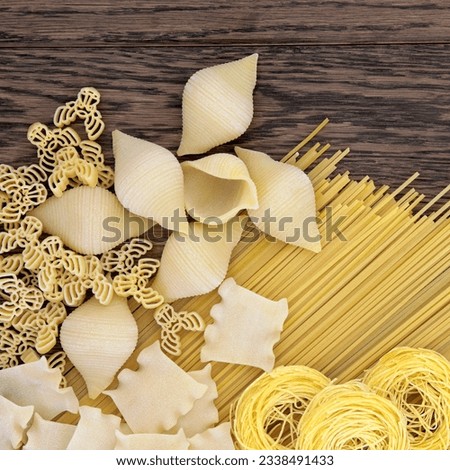 Abstract pasta food selection forming a background over old oak wood.