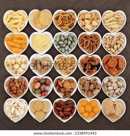 Savoury snack food selection in heart shaped porcelain dishes.