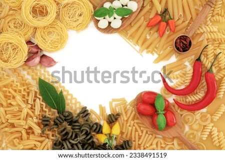 Italian pasta and food ingredients forming an abstract border over white background.