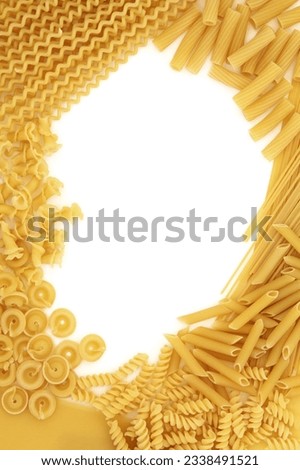 Dried pasta and spaghetti abstract border over white background.