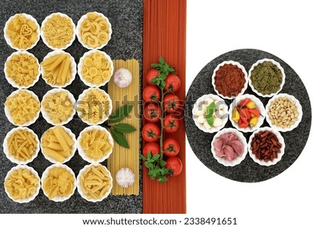 Italian and mediterranean food ingredients in porcelain bowls on marble over white background with tomato spaghetti.