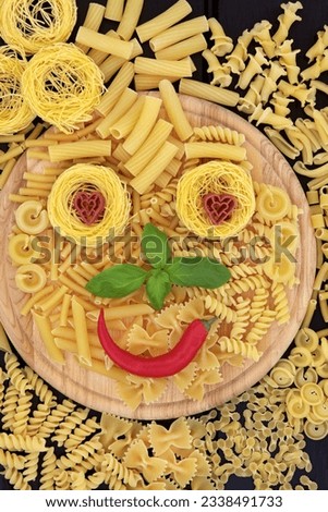 Pasta smiley face abstract background on a wooden board.