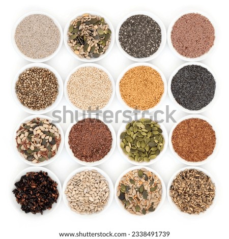 Seed and nut health food in porcelain bowls over white background.