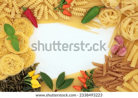 Pasta dried food abstract border with herbs and spices over white background.