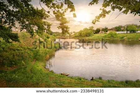 Beautiful sunset over lake near a village