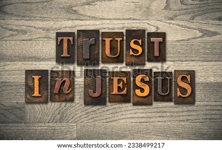 The words TRUST IN JESUS written in vintage wooden letterpress type.