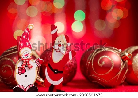 Christmas ornaments santa claus and sow man with blurry glitter shiny lights at background.