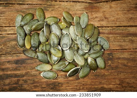 pumpkin seeds close up on wooden table