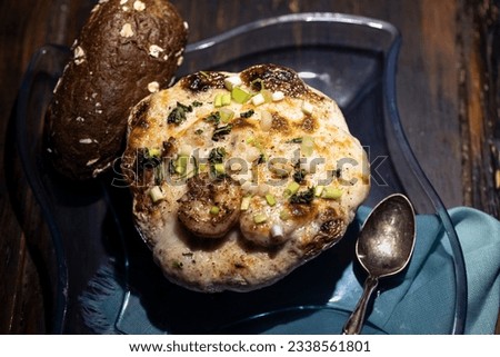 Au gratin served in a patty pan squash with bread. Royalty-Free Stock Photo #2338561801
