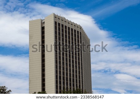 View of a Modern Office Building Against the Background of the Sky Extending Towards the Clouds.