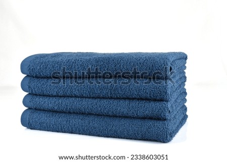 Pack of 4 Blue Bath Towel stack of clean towels isolated with white background 3 side view of folder Royalty-Free Stock Photo #2338603051