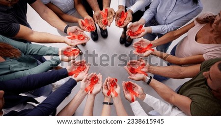 HIV AIDS Patient Treatment Charity Support And Red Awareness Ribbon Royalty-Free Stock Photo #2338615945