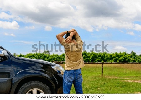 Man driver is stretching after a long dirve. He exercises his body to relieve his body pain. Royalty-Free Stock Photo #2338618633