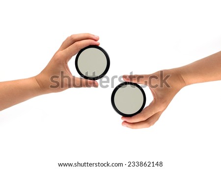 Two hand holds a ND (neutral density) optical filter isolated on white