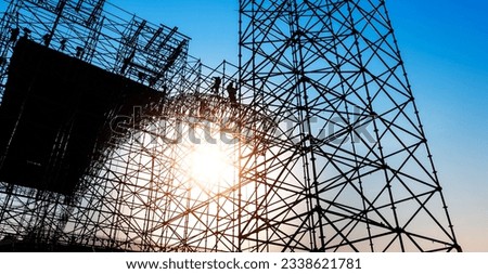 Group of construction workers working on scaffolding Royalty-Free Stock Photo #2338621781