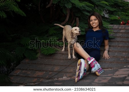 young female skater with her adorable dog