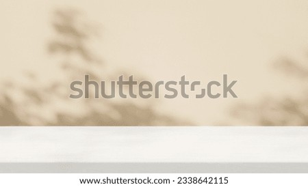 Minimal White Wood Table with Tree Shadow on Beige Concrete Wall Texture Background, Suitable for Product Presentation Backdrop, Display, and Mock up.