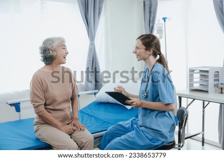 Portrait of beautiful doctor sharing data from digital tablet with elderly patient