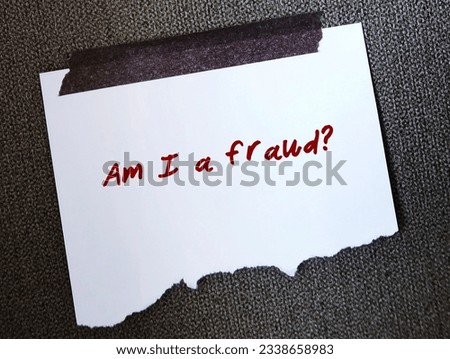 Torn note on wallpaper with handwritten text AM I A FRAUD? concept of IMPOSTER SYNDROME, feelings of doubt one own skills, talents or accomplishments , have a persistent fear of being exposed a fake Royalty-Free Stock Photo #2338658983