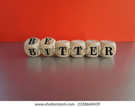 Better or bitter symbol. Concept word Better and Bitter on wooden cubes. Beautiful grey table red background. Business and better or bitter concept. Copy space. Royalty-Free Stock Photo #2338660439