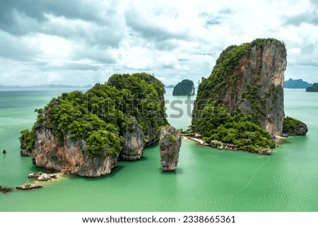 Khao Tapu, James Bond Island, aerial shot from a drone, blue sea, emerald green, is a popular tourist attraction in Southern Thailand. Royalty-Free Stock Photo #2338665361