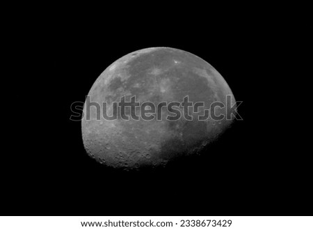 A detailed photo of a gorgeous wanning gibbous moon 65% in the dark night sky.