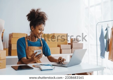Pretty African American sme business woman working Custom Ecommerce Packaging leading supplier of custom packaging. create a personalised experience, fast production and competitive pricing Royalty-Free Stock Photo #2338683161