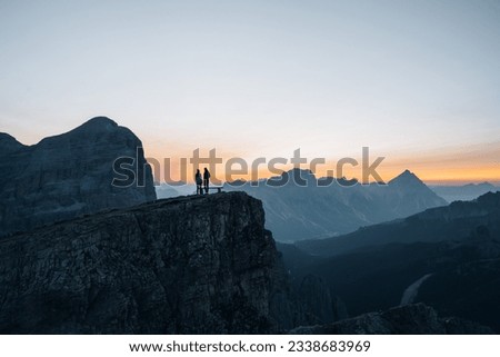 Silhouette of a couple during a morning sunrise in the mountains of Italy