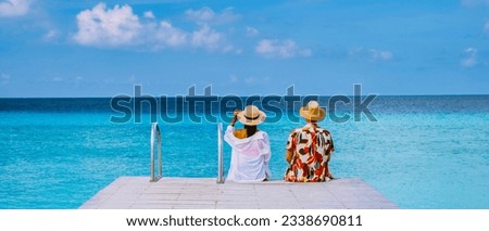a couple visit Playa Porto Marie beach Curacao, white tropical beach with turqouse water ocean, couple men and women on vacation in Curacao Royalty-Free Stock Photo #2338690811