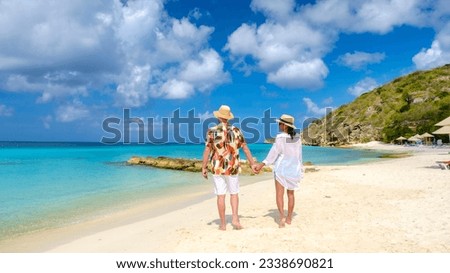 Playa Porto Marie Beach in Curacao, a tropical beach on the Caribbean Island of Curacao. A couple of men and women on the beach in Curacao Royalty-Free Stock Photo #2338690821