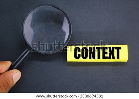 magnifying glass and letters of the alphabet with context words. the concept of context