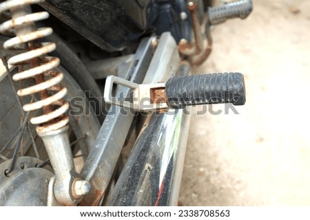 black motorcycle footrest or motorcycle foot peg made of iron and black rubber For the pillion and convenience for drivers Helps to place the feet and makes stacking more convenient. Royalty-Free Stock Photo #2338708563