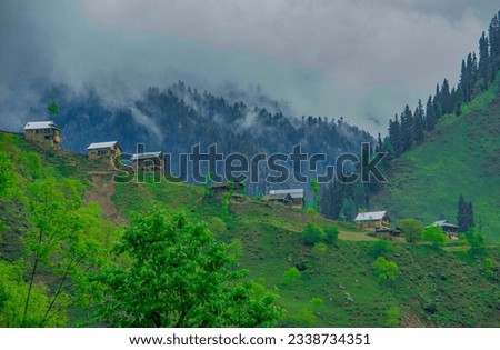 wooden huts in green mountains 