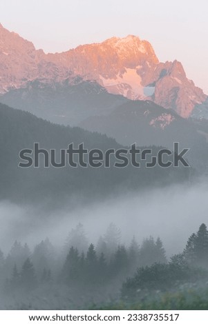 Morning view of Zugspitze at a foggy sunrise at Geroldsee, Bavaria Germany Royalty-Free Stock Photo #2338735517
