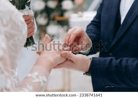 groom puts wedding ring on bride finger, wedding ceremony, love and family concept