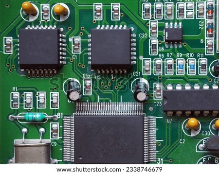 Square-shaped 28-pin programmable integrated circuits on PCB. Noname chips.  Royalty-Free Stock Photo #2338746679