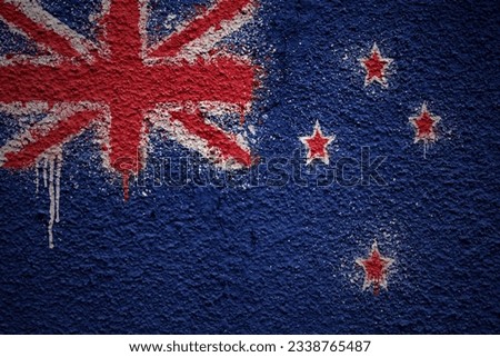 colorful painted big national flag of new zealand on a massive old cracked wall