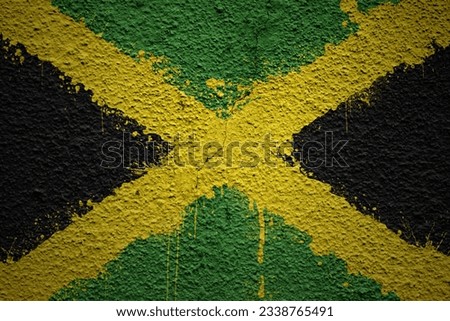 colorful painted big national flag of jamaica on a massive old cracked wall Royalty-Free Stock Photo #2338765491
