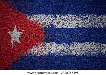 colorful painted big national flag of cuba on a massive old cracked wall