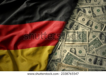 big colorful waving national flag of germany on a american dollar money background. finance concept