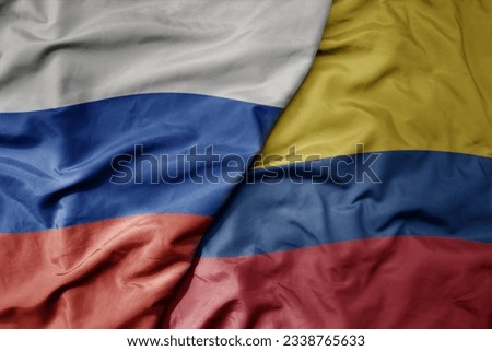 big waving realistic national colorful flag of russia and national flag of colombia . macro