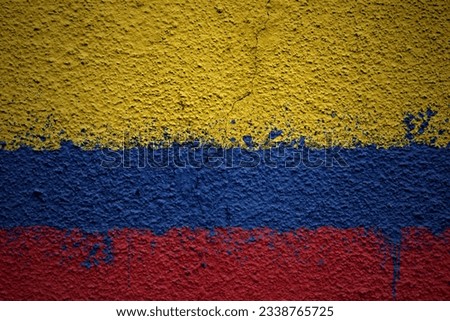 colorful painted big national flag of colombia on a massive old cracked wall