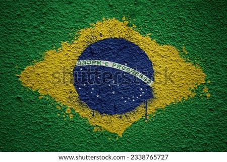 colorful painted big national flag of brazil on a massive old cracked wall