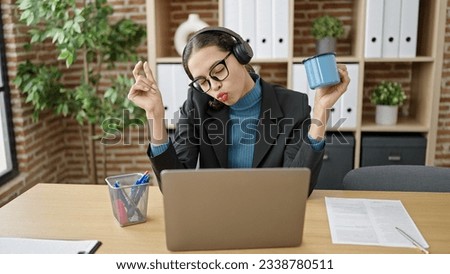 Young beautiful hispanic woman business worker using laptop working dancing at office