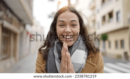 Young beautiful hispanic woman standing with surprise expression at street