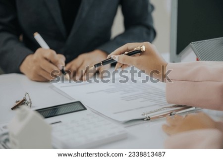 Male businessman or real estate agent holding house key for his client after signing contract in office concept for real estate Moving house or renting property	 Royalty-Free Stock Photo #2338813487